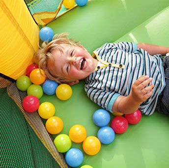 Little Boy In A Bounce House